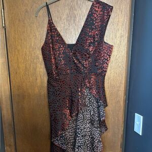 Asymmetrical black/red top. Evening wear.